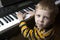 Talented little boy sitting at the piano