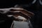 Talented pianist plays classical melody on piano in the dark. Detailed close up shot of a mans hands touches the white