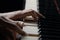 Talented pianist plays classical melody on piano. Detailed close up shot of a mans hands touches the white and black