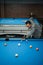 talented pool player poking the white ball