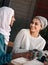 Talk about a good coffee date. two affectionate young girlfriends having a chat at a coffee shop while dressed in hijab.