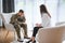 Talking to doctor. Soldier have therapy session with psychologist indoors