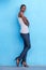 Tall african fashion model standing with tank top and jeans