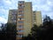 Tall apartment building of the late socialism era. Yellow facade, balconies and loggias, residential condition.