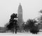 Tall Art Deco church towering above trees in the snow - black and white