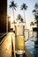 Tall beer glasses with flutes laid out on a wooden terrace by the pool at the seaside resort