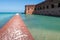 Tall brick walls of an old military fort on an island of Dry Tortugas. Florida. Blue sky, green water, beautiful summer