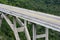 Tall bridge crossing a green valley