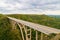 Tall bridge crossing a tropical valley