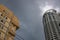 Tall building on stormy sky, view from ground. Office and living building architecture. Modern asian city landscape