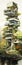 Tall building with tree top design exposure in Rei covered veget