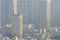 Tall buildings in industrial city with hazy smog sky