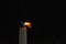 Tall candle blown off in the dark environment