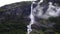 Tall cascading waterfalls in the Norwegian mountains on a cloudy day, Norway