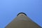 Tall cement tower structure with blue sky