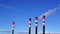 Tall chimneys in blue sky, air pollution