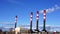 Tall chimneys in blue sky, air pollution