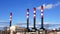 Tall chimneys in blue sky, air pollution