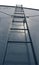 Tall commercial step ladder against the blue wall background