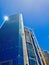 Tall Commercial Tower With Construction Cranes and Blue Sky