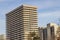 Tall Condominium Building Against Blue Sky Background