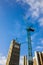 Tall crane operating on a construction site of high-rise apartments in England, UK