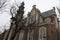 Tall Dutch buildings built in red bricks in the style of Amsterdam. cold autumn day, gray and cloudy