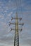 Tall electric pylon leading high current and voltage as a symbol of electricity and technological progress