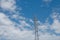 Tall electricity power line grid generator pole with blue sky