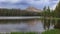 Tall evergreen trees by scenic Crystal lake in Uinta Wasatch national forest