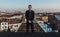 Tall forty year old man standing on his roof, overlooking the Brussels skyline