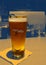 Tall glass of cold beer on counter