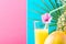 Tall Glass with Freshly Squeezed Pineapple Citrus Tropical Fruit Juice with Straw and Flower. Fuchsia Pink Blue Duotone Background