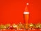 Tall glass of pale ale or beer with red santa hat christmas baubles tinsel and lights - cristmas drink background