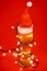 Tall glass of pale ale or beer with red santa hat and lights - c