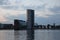 Tall grain silo with its reflection in the river in Aalborg, Denmark