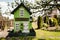 Tall green birdhouse on a tree