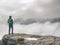 tall hiker on sharp cliff of sandstone rock in rock park