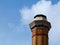 Tall industrial chimney stack of yellow and red brick of octagonal base