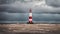 Tall lighthouse at the north sea under a cloudy sky