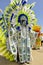 A tall male celebrant is dressed in Indian garb on Carnival Day in Trinidad