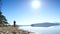 Tall man with sunglasses, red baseball cap and blue black sportswear is running and exercising on the beach at midday. Sport ac