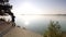 Tall man with sunglasses, red baseball cap and red black sportswear is running and exercising on beach. Sport active man