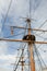 Tall mast on old ship with rigging