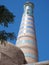 Tall minaret mixed with cyan, blue and turquoise mosaics