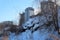 Tall modern houses new buildings near a pile of garbage in the snow