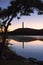 Tall obelisk monument on a mountain reflecting in still water at sunrise. High Point State Park, New Jersey