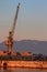 Tall old grey port crane in morning in Rijeka harbor Croatia