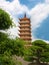Tall pagoda at Vinh Trang temple, near My Tho, Vietnam. Low angle view from the gardens.