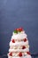 Tall Pavlova cake with whipped cream and strawberry